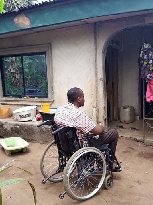 Man in wheelchair outside a home